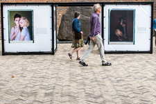 838402 Afbeelding van de twee foto-expositie-kubussen bij de runensteen (midden) met enkele passanten op het Domplein ...